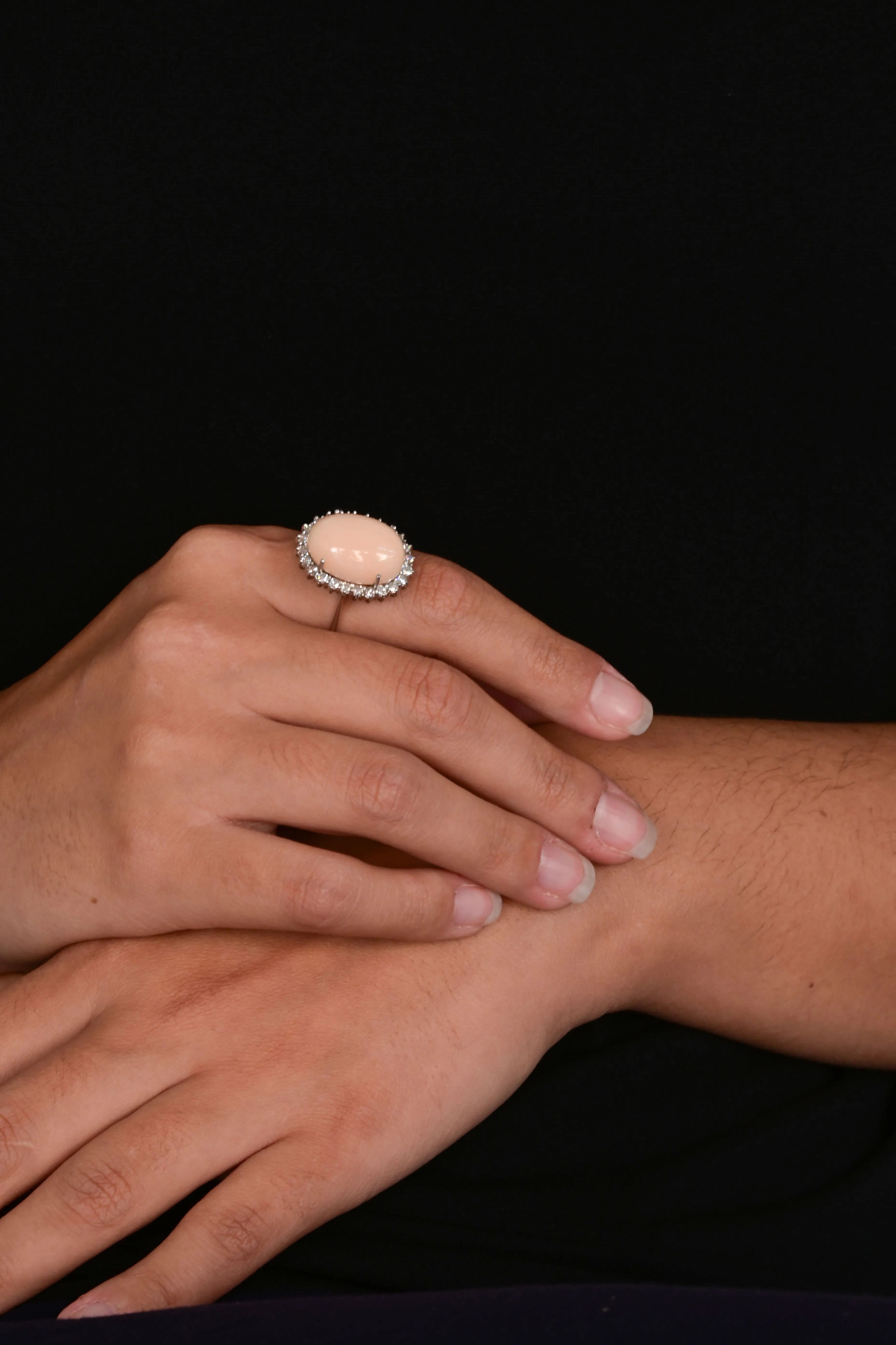 Angel skin coral Ring with a diamond halo.