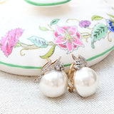 Mabe pearl and diamond earrings in 18k white gold and platinum with 12 diamonds.