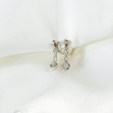 Antique diamond earrings with a three bodies in an illusion mouth and pendulum.