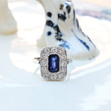 Bague vintage avec un saphir octogonal central et 12 diamants taillés brillants en or blanc 18k.
