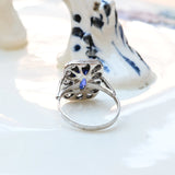 Vintage ring, made of white gold, with a central octagonal sapphire and 12 brilliant cut diamonds.