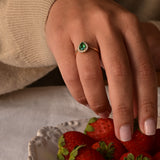 Emerald and diamond ring with pear-cut emerald and 17 diamonds in 14K yellow gold.