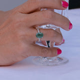 Emerald engagement ring with 3.22 ct green semi-transparent emerald and 86 diamonds in 14K white gold.