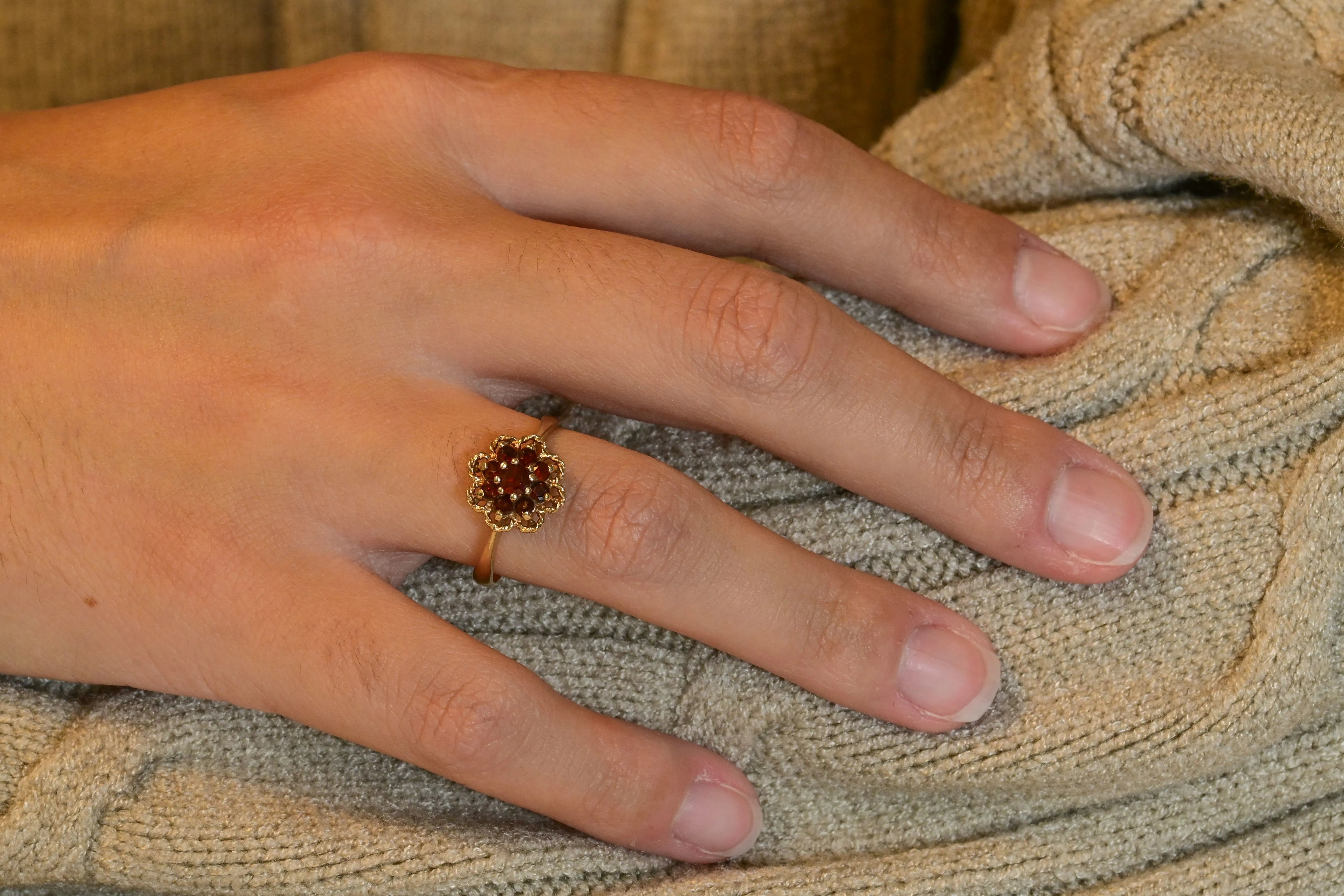 Elizabethan style rosette ring with garnets in yellow gold.