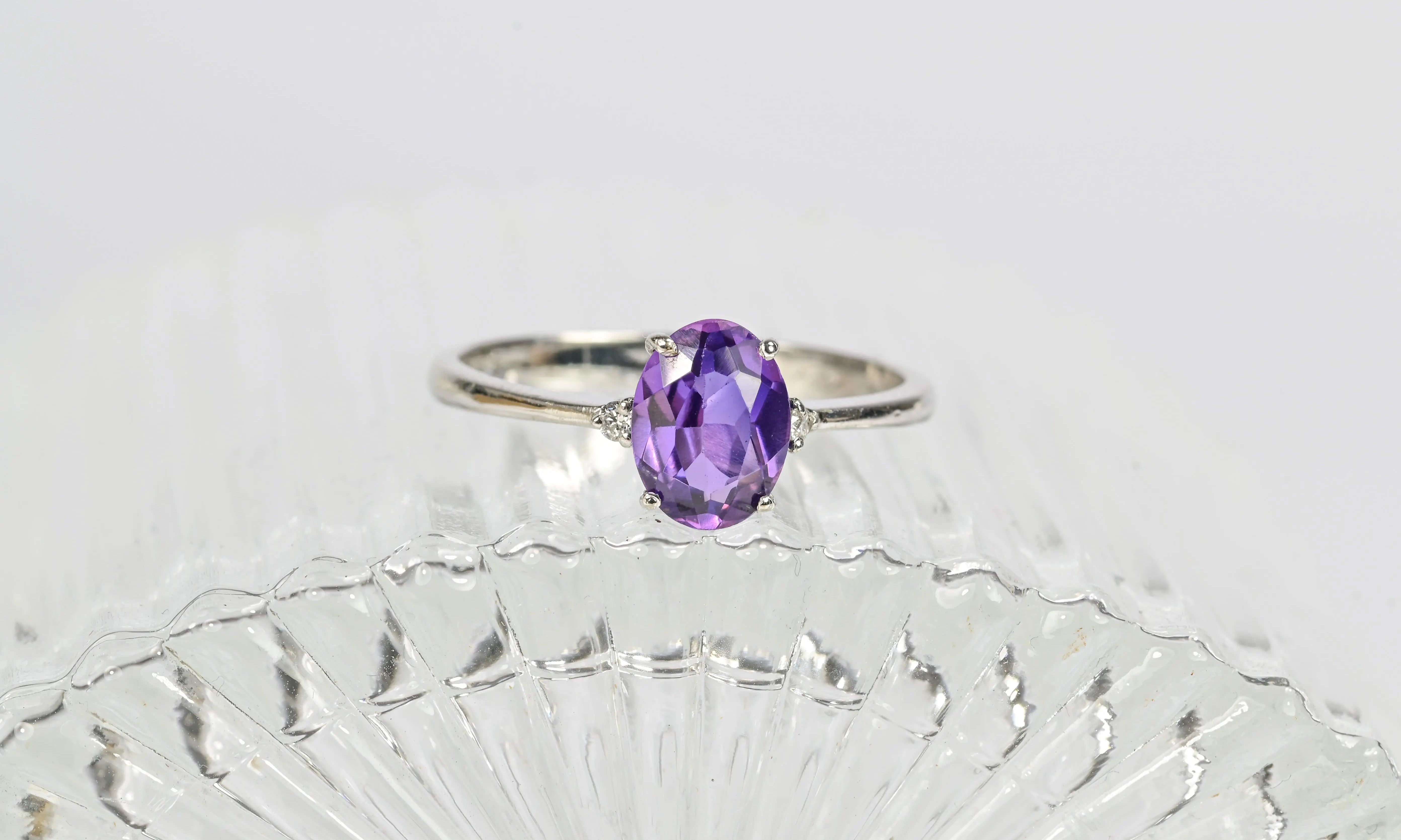Antique engagement ring with a central amethyst stone and surrounding diamonds