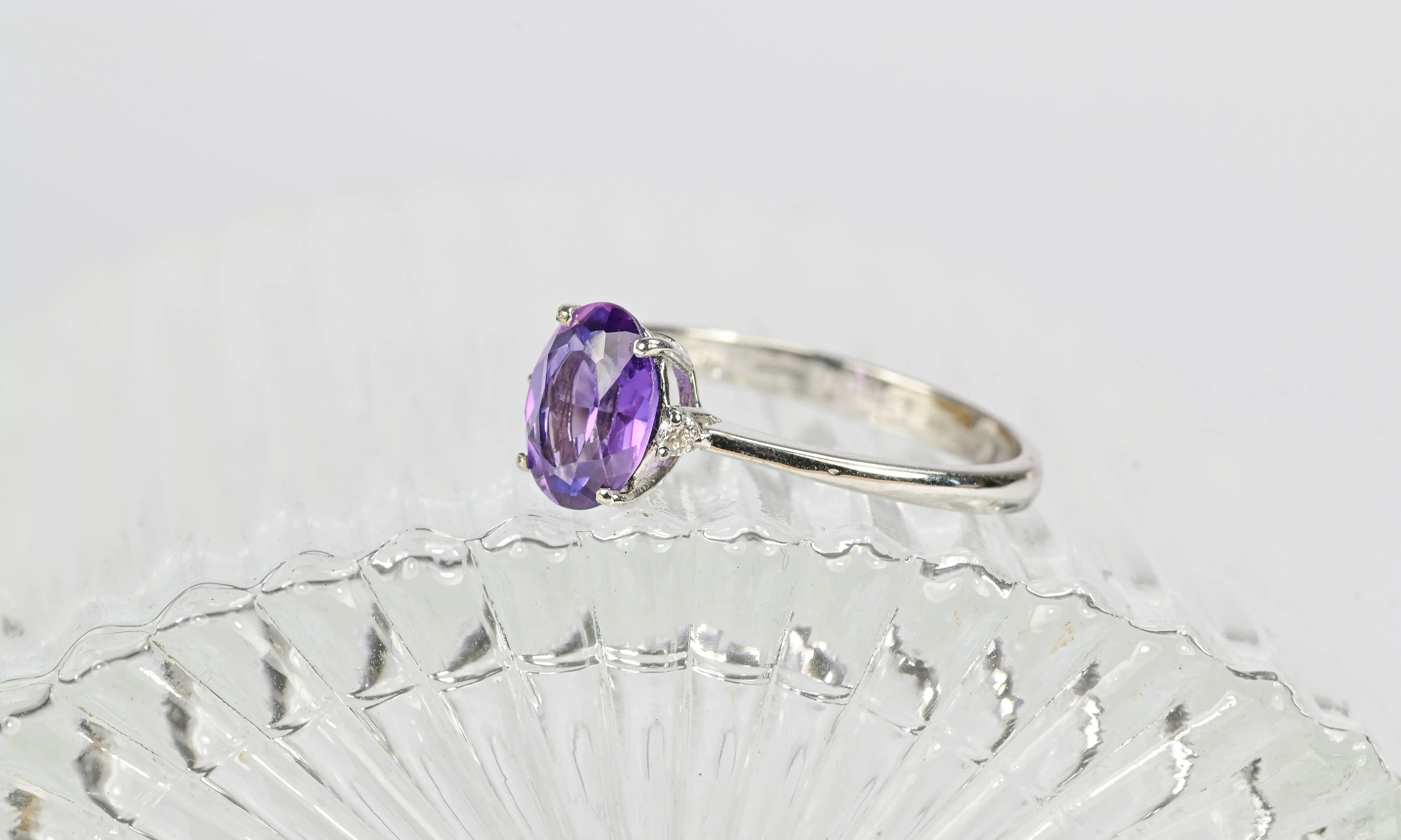 Vintage ring featuring a central amethyst and encircled by diamonds