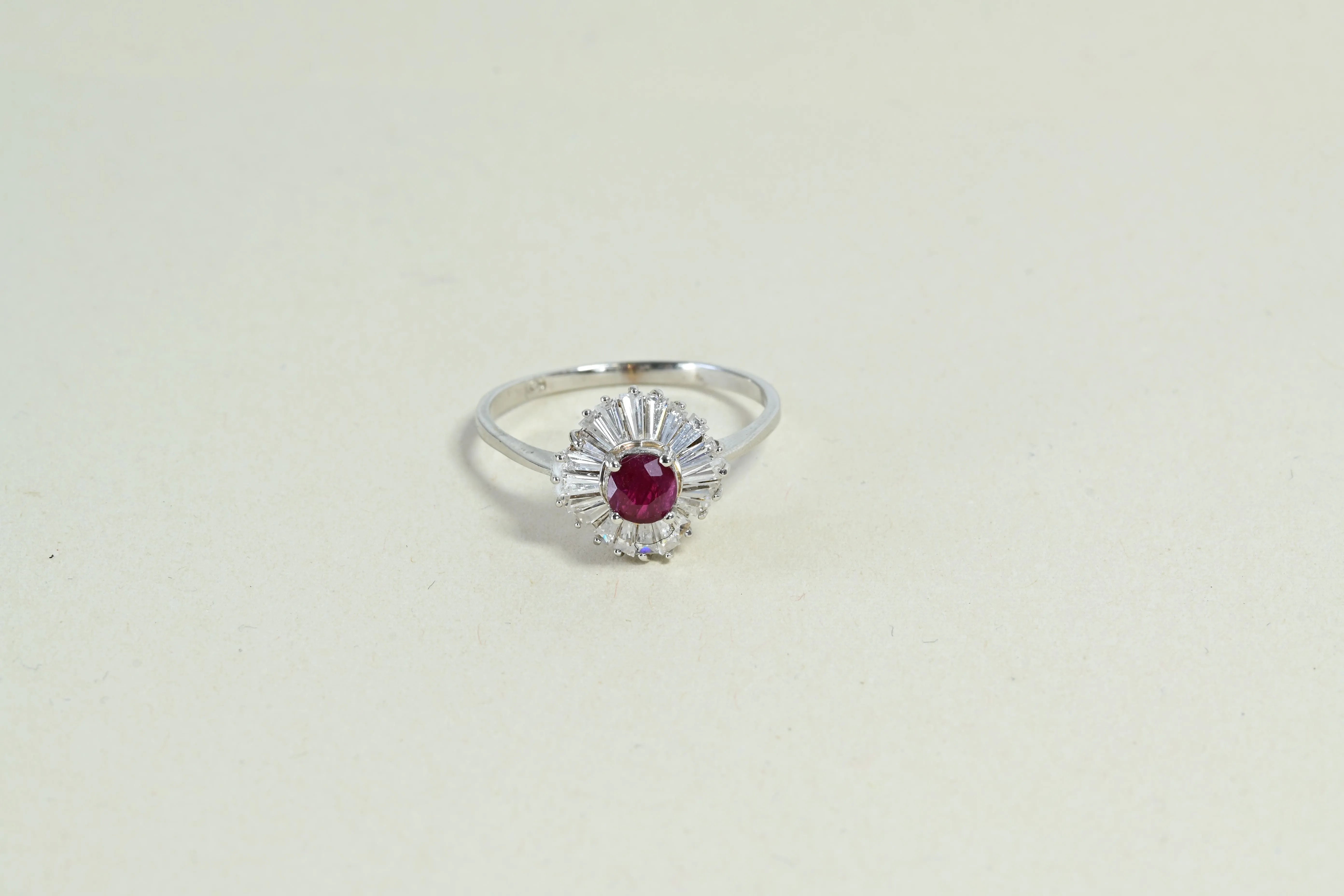 Ballerina style ring with a central ruby and 20 baguette diamonds.