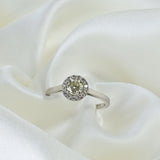 Yellow diamond engagement ring with a halo of white diamonds, set in 14k white gold.