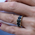 Vintage band ring composed by 5 oval cut sapphires and 4 octagonal cut diamonds set in the spaces between sapphires.