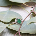 Vintage cocktail ring with emeralds and diamonds.