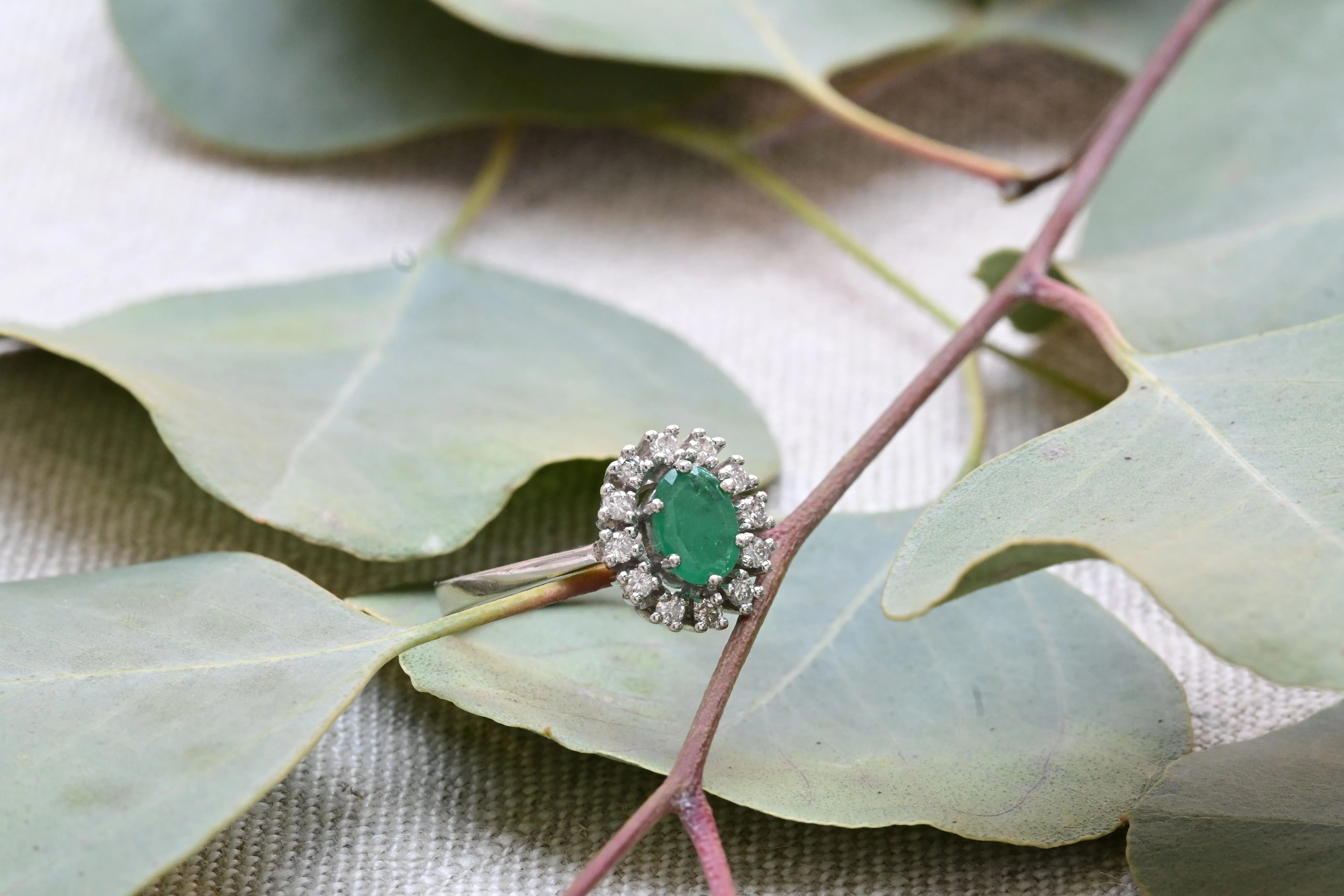 Vintage cocktail ring with emeralds and diamonds.