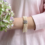 Elegant Akoya pearl bracelet featuring rubies and white gold details.