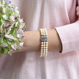 Elegant Akoya pearl bracelet featuring rubies and white gold details.