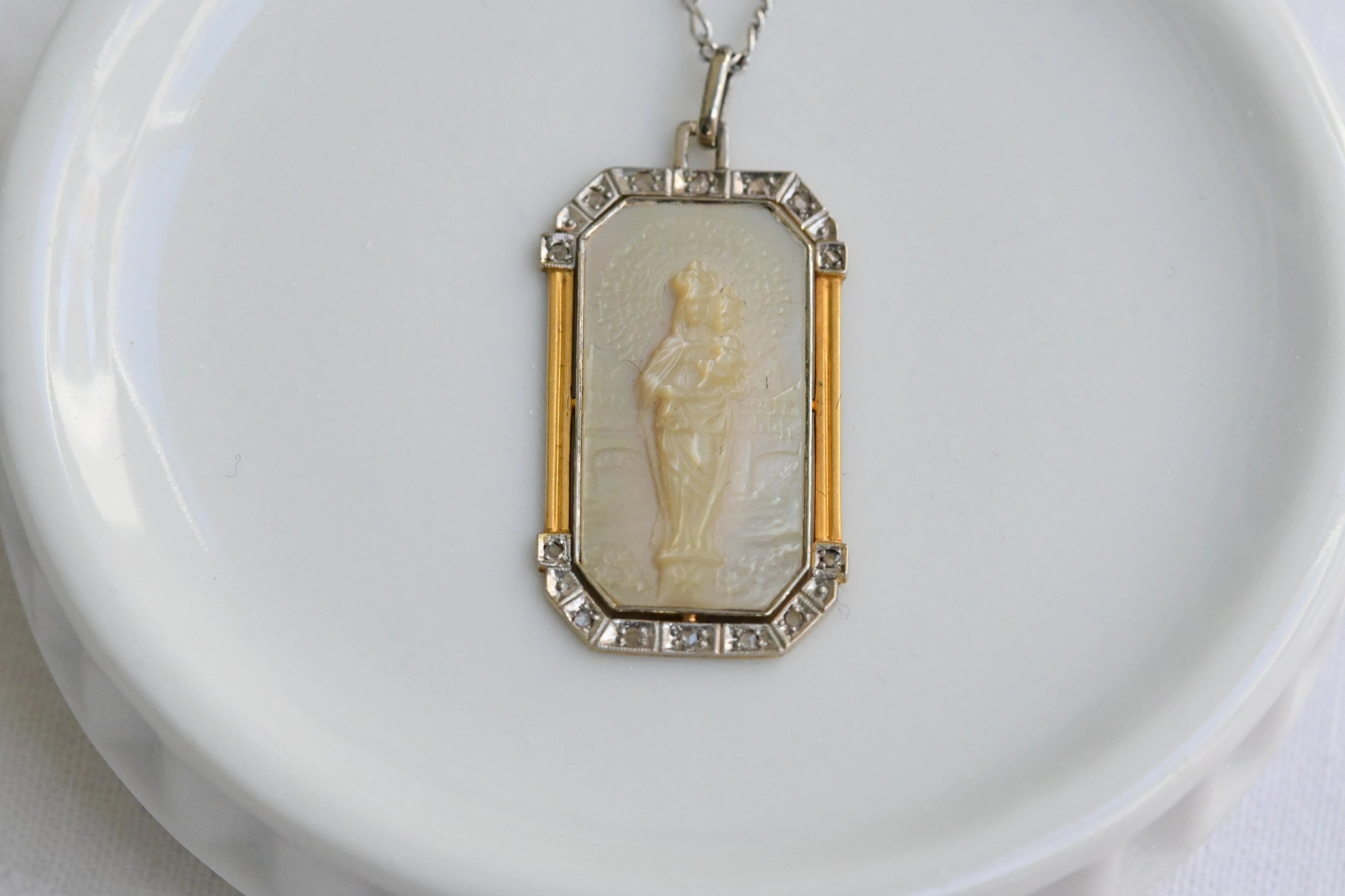 Art deco necklace with religious motif carved in mother of pearl