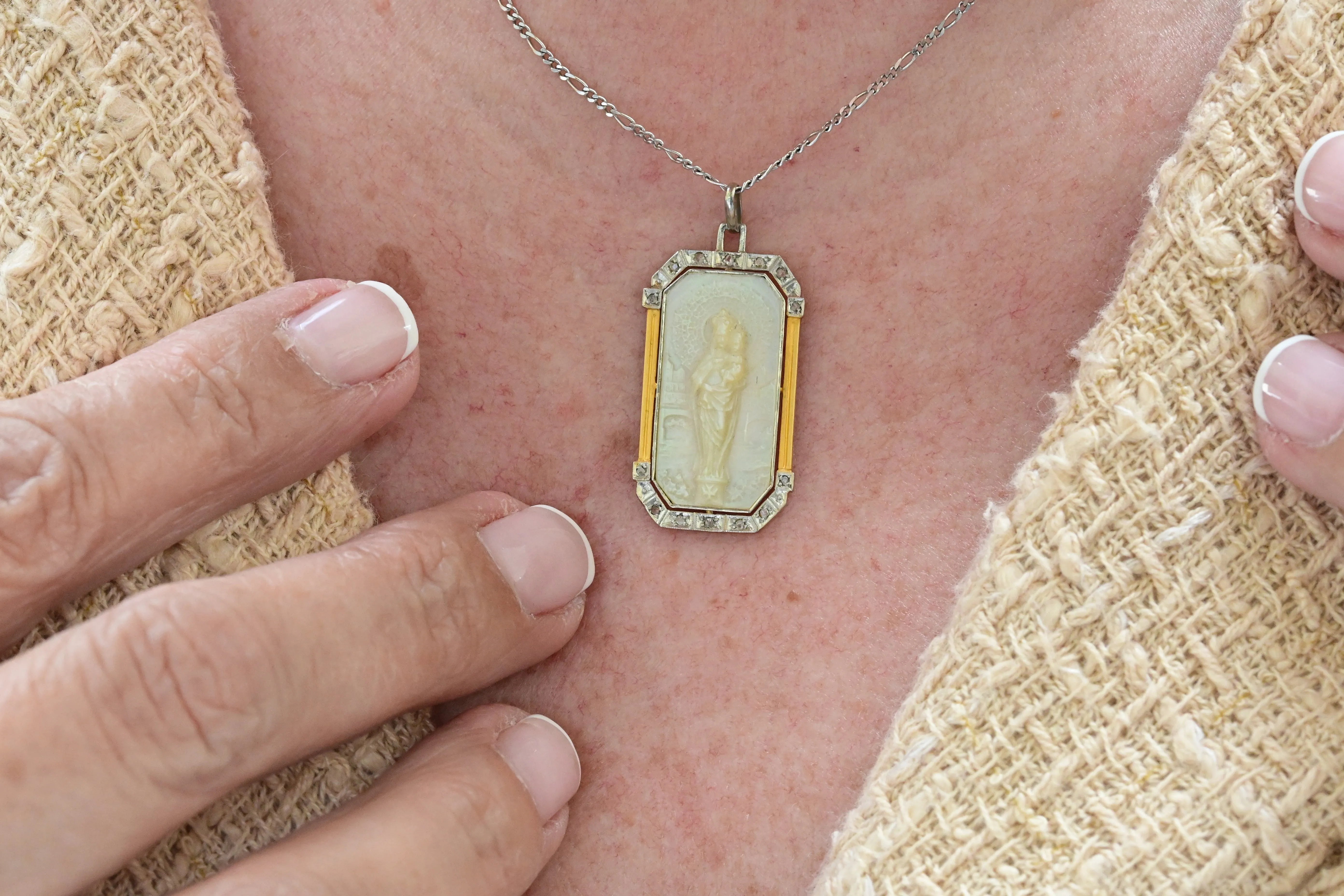Art deco necklace with religious motif carved in mother of pearl