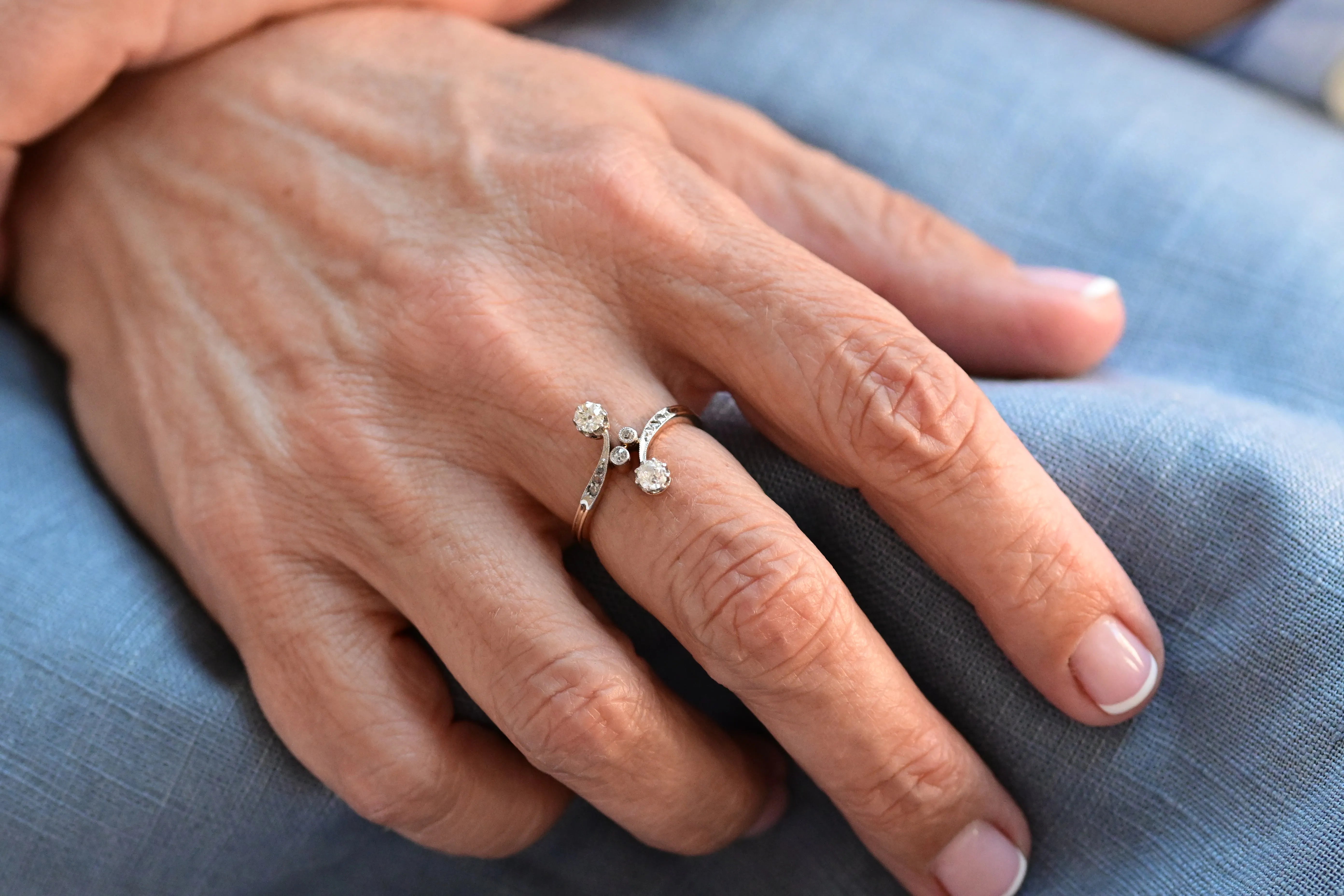 Vintage "You and Me" ring featuring old European cut diamonds and rose cut diamonds set in platinum and 14K yellow gold.