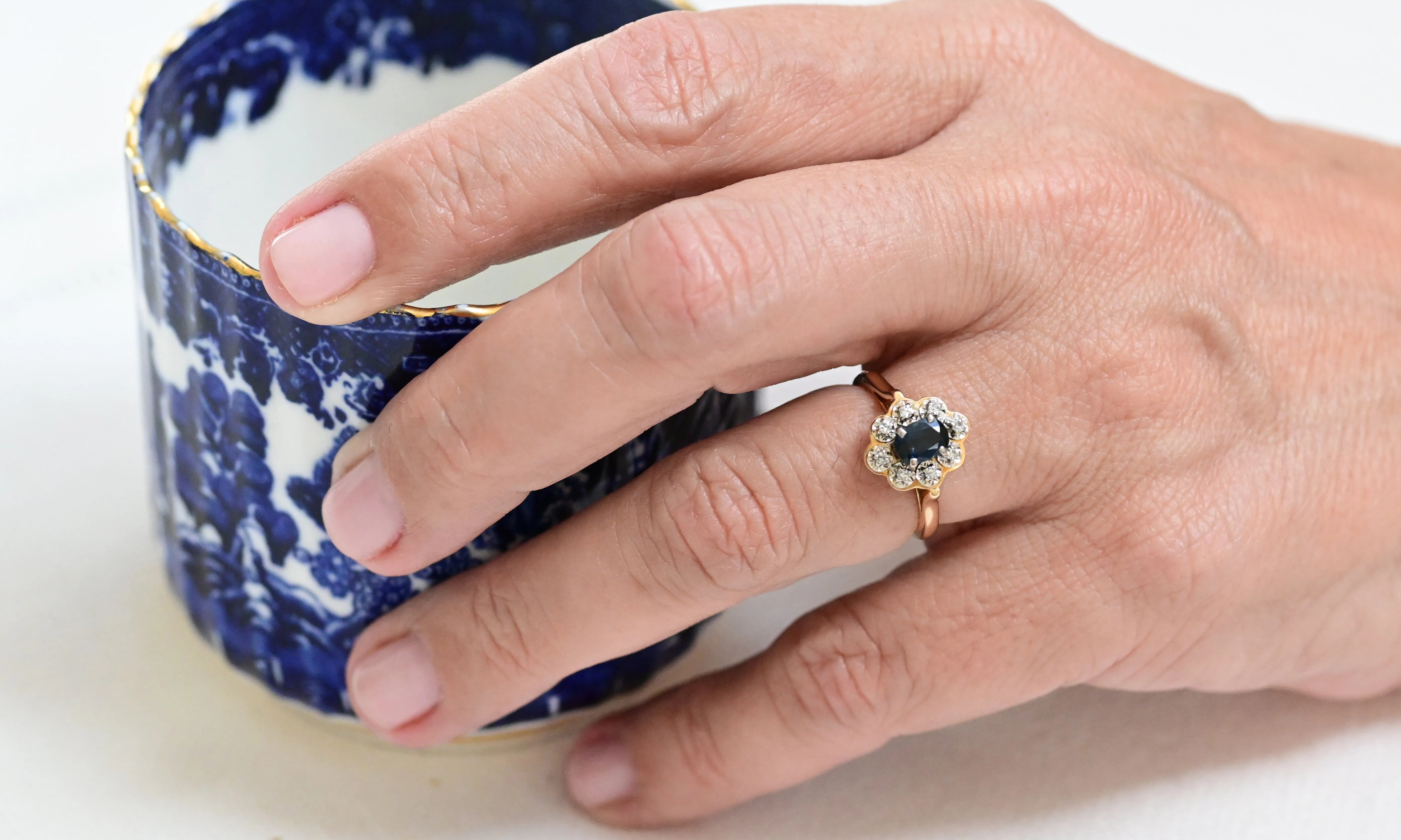 Vintage Entourage Ring with a Central Sapphire and Surrounded by Diamonds