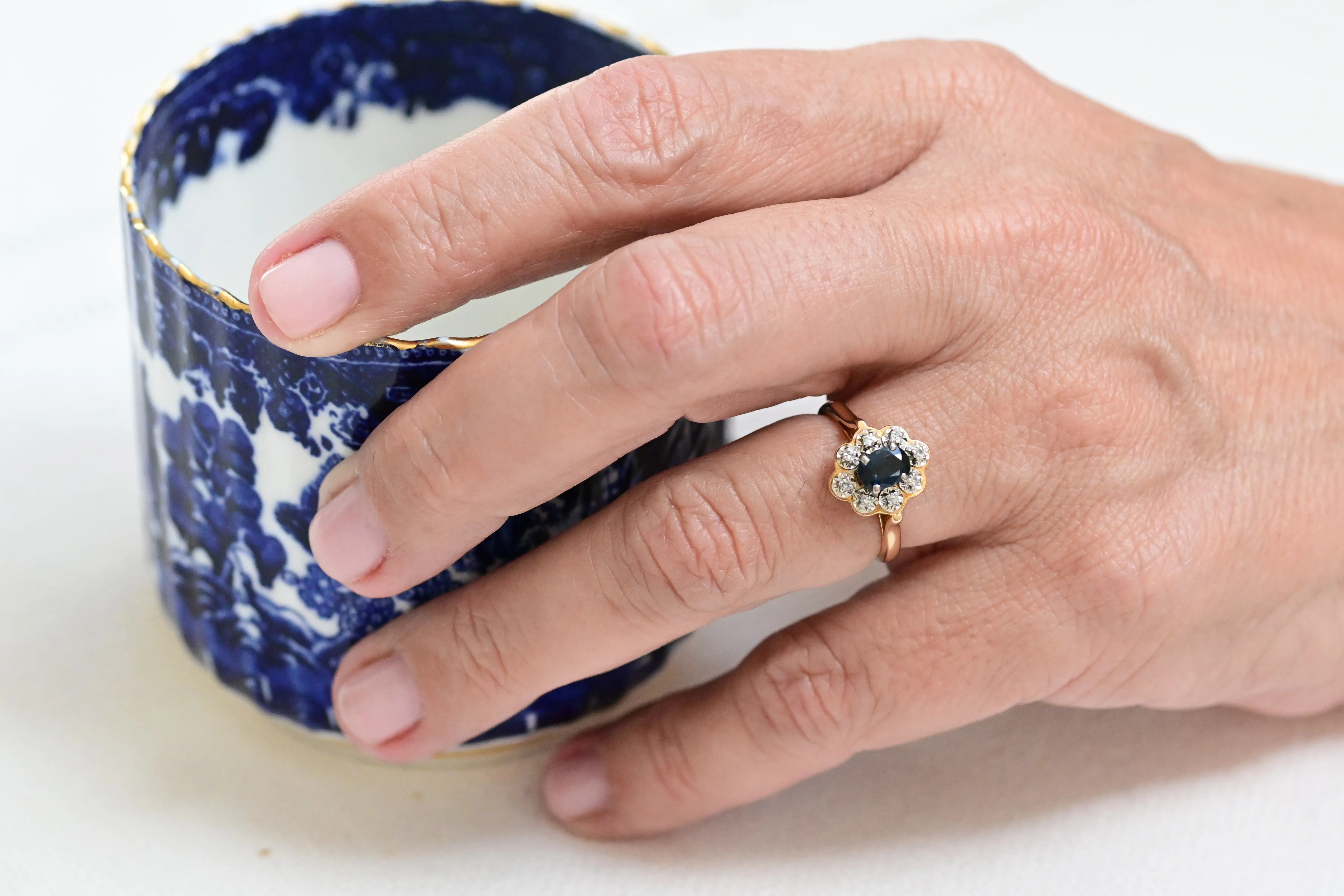 Vintage Entourage Ring with a Central Sapphire and Surrounded by Diamonds