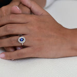 Vintage Engagement Ring with a Central Sapphire and Halo of Diamonds