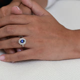 Vintage Engagement Ring with a Central Sapphire and Halo of Diamonds