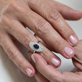 Vintage oval sapphire ring with diamonds, set in 18K white gold.