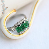 Vintage ring with 3 central emeralds and 10 round cut diamonds, set in 18K white gold.