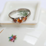 Trinity ring with fancy vivid orange diamonds