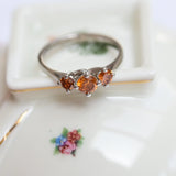 Trinity ring with fancy vivid orange diamonds