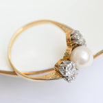 Elegant vintage diamond and pearl ring in yellow gold with European cut diamonds.