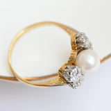 Elegant vintage diamond and pearl ring in yellow gold with European cut diamonds.