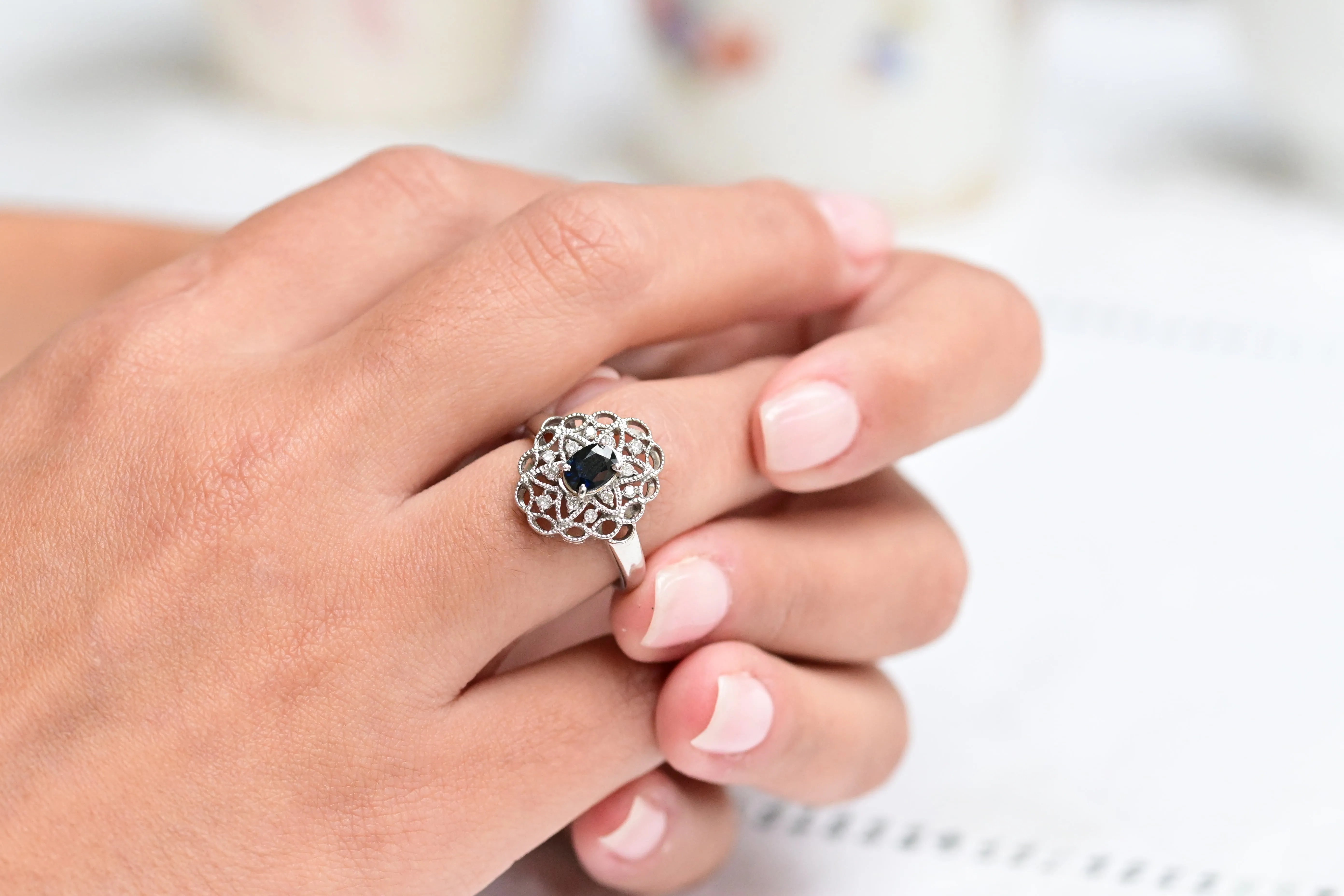 Vintage platinum ring with oval sapphire and round cut diamonds.