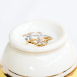 Flower diamond ring in 18K yellow gold with brilliant cut diamonds.